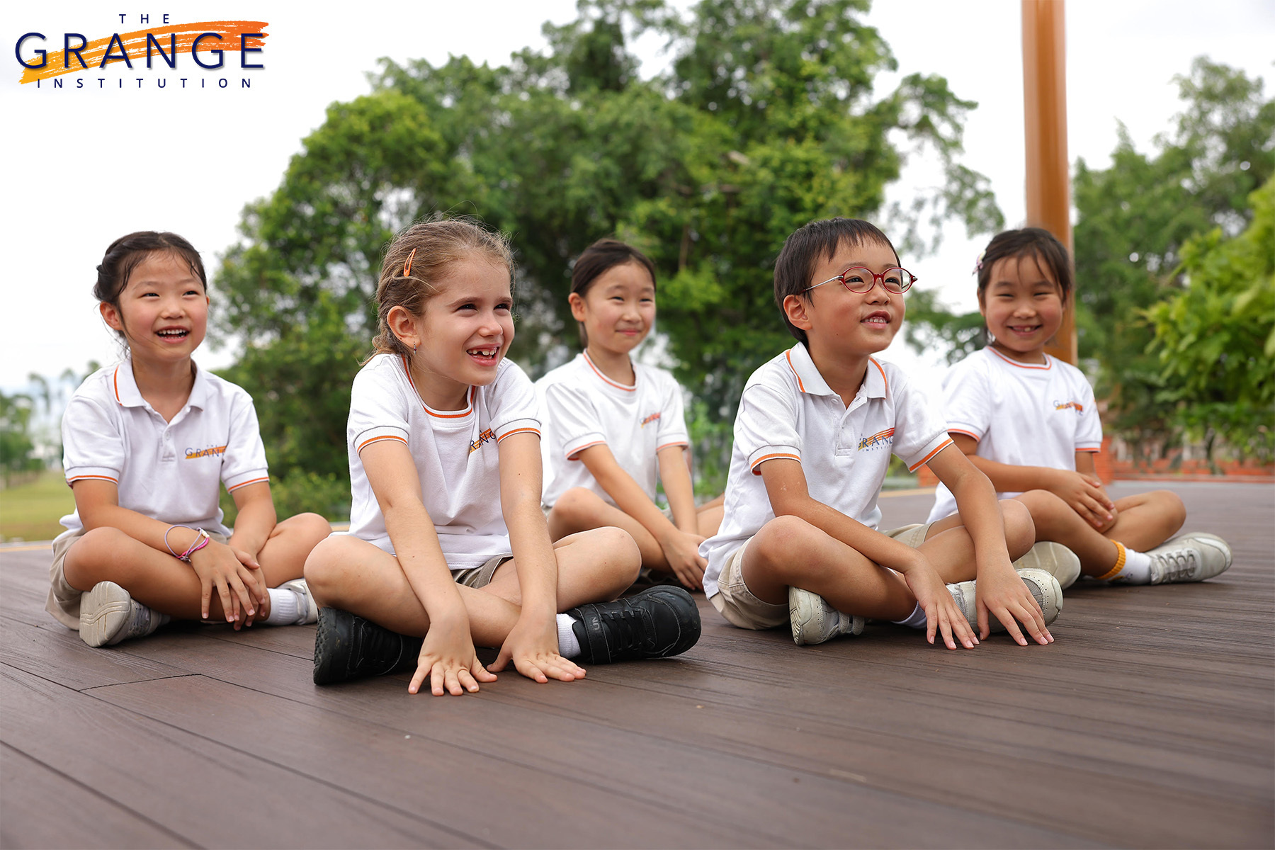 Children in a primary international school smiling at the camera