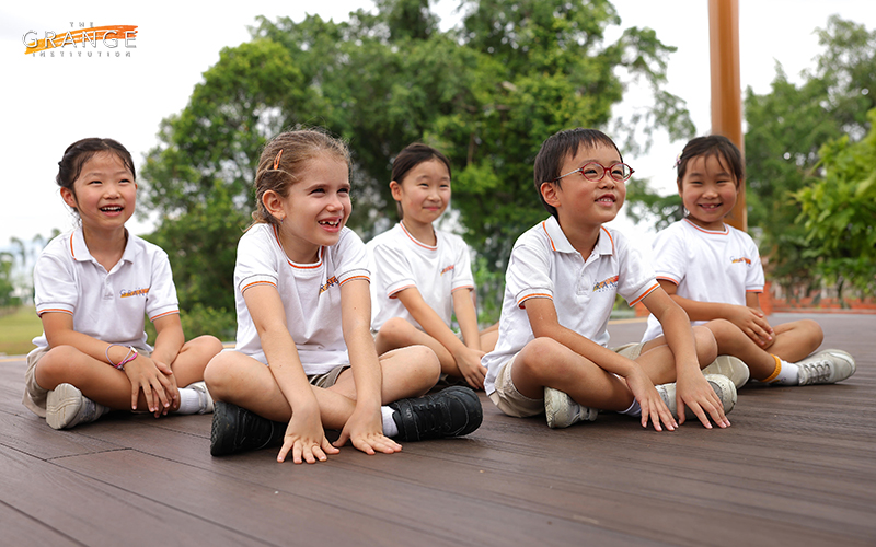 Children in a primary international school smiling at the camera